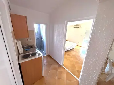 a small kitchen with a sink and a stove at ADO Apartmani Ulcinj Velika Plaza Donji Stoj in Donji Štoj
