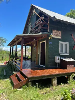 a house with a wooden porch and a deck at Velicanka hostel in Ulcinj