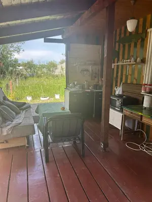 a living room with a table and a kitchen at Velicanka hostel in Ulcinj
