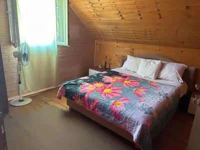 a bedroom with a bed with a colorful blanket at Velicanka hostel in Ulcinj