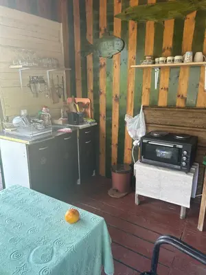 a kitchen with a table with an orange on it at Velicanka hostel in Ulcinj