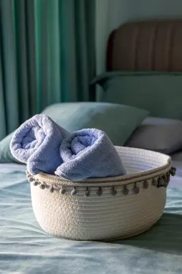 a bowl with a purple towel sitting on a bed at Center Blue & Green in Budva