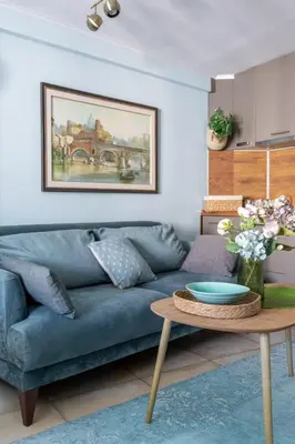 a living room with a blue couch and a table at Center Blue & Green in Budva
