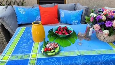 a blue table with flowers and a bowl of fruit at Center Blue & Green in Budva