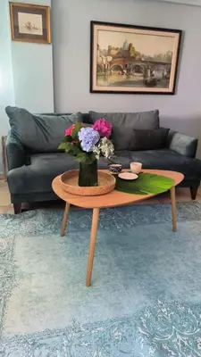 a living room with a table with a vase of flowers on it at Center Blue & Green in Budva