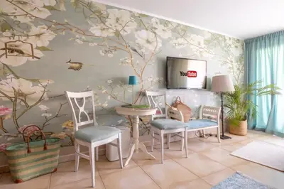 a room with chairs and a table with flowers on the wall at Center Blue & Green in Budva