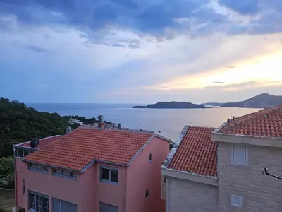 a view of the ocean from between two buildings at Panorama Milocer Apartments in Budva