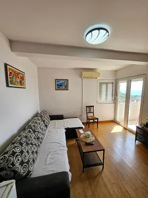 a living room with a couch and a table at Panorama Milocer Apartments in Budva