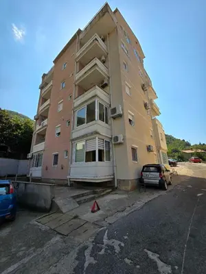 a large apartment building in a parking lot at Panorama Milocer Apartments in Budva