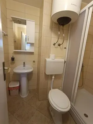 a small bathroom with a toilet and a sink at Guest house Rade Z in Budva