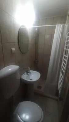 a bathroom with a toilet and a sink and a shower at Guest house Rade Z in Budva