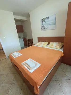 a bedroom with a bed with two towels on it at Guest house Rade Z in Budva