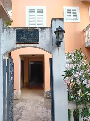 a building with a sign that reads dogs works school at Mota saste lux in Sveti Stefan