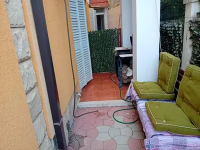 a patio with a couch and chairs on a porch at Mota saste lux in Sveti Stefan