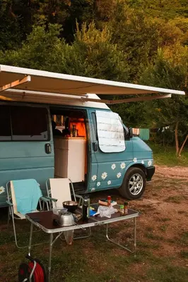 a blue van with a table in front of it at GoCamping Montenegro in Cetinje