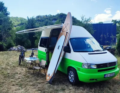 a white and green van with a surfboard on the door at GoCamping Montenegro in Cetinje