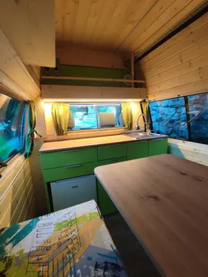 a kitchen with a wooden table and a sink at GoCamping Montenegro in Cetinje
