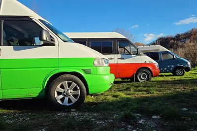 a group of parked vans parked in a field at GoCamping Montenegro in Cetinje