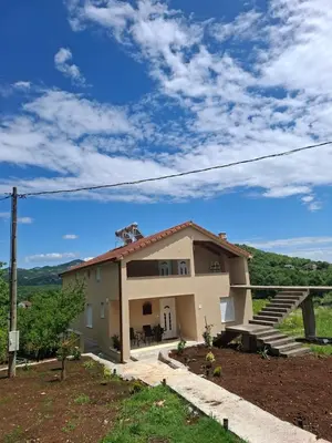 a house on the side of a hill at Apartmani Suvodoli in Rvaši