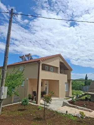 a house with a pole in front of it at Apartmani Suvodoli in Rvaši