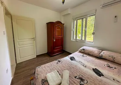 a bedroom with two beds and a window at Apartmani Suvodoli in Rvaši