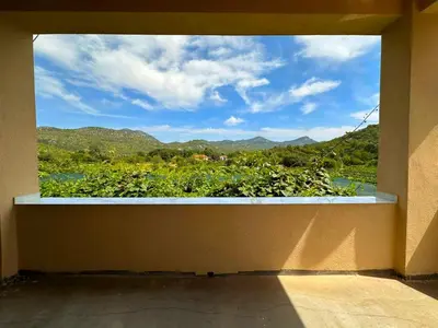 a window in a room with a view of the mountains at Apartmani Suvodoli in Rvaši