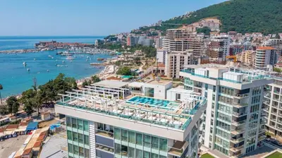 an aerial view of a city and the ocean at Luxury 3 bedroom flat in Tre canne hotel next to the beach in Budva