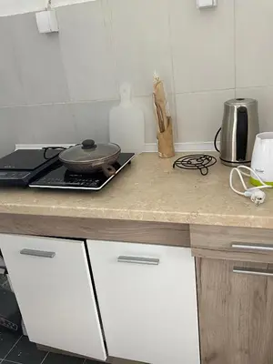 a kitchen counter with a pan on top of it at Апартаменты in Sutomore