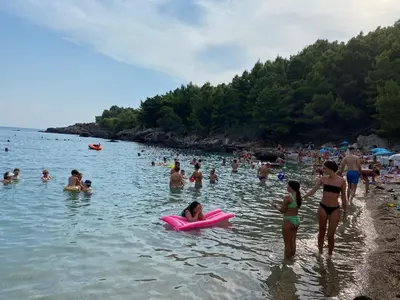 a group of people in the water at a beach at Апартаменты in Sutomore