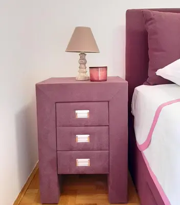 a purple nightstand with a lamp on it next to a bed at Luča apartman in Podgorica