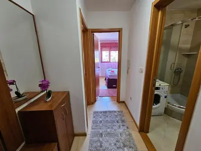 a hallway with a bathroom with a sink and a toilet at Luča apartman in Podgorica