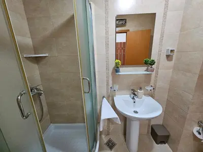 a bathroom with a sink and a shower at Luča apartman in Podgorica