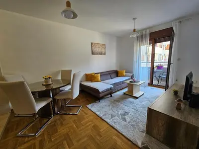 a living room with a couch and a table at Luča apartman in Podgorica