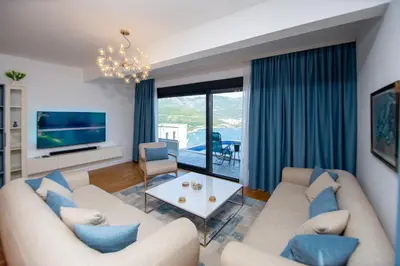 a living room with two couches and a tv at Villa Maya in Budva