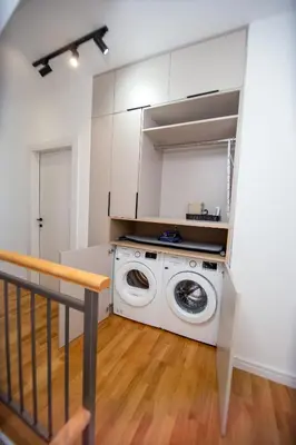 a washer and dryer in a white laundry room at Villa Maya in Budva