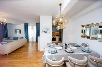 a living room with a table and a couch at Villa Maya in Budva
