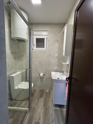 a small bathroom with a sink and a toilet at NNL Apartments in Sutomore