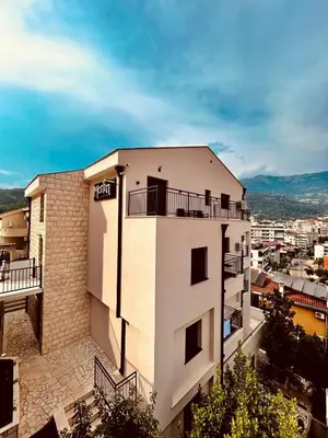 a building with a balcony on top of it at Merlin Prestige Apartments in Budva