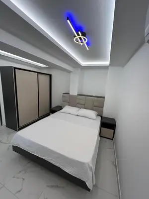 a bedroom with a bed and a ceiling fan at Merlin Prestige Apartments in Budva