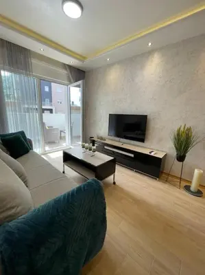 a living room with a couch and a flat screen tv at Old barkery, the most exclusive complex in Budva in Budva