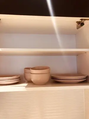 a shelf with three bowls and plates on it at Old barkery, the most exclusive complex in Budva in Budva