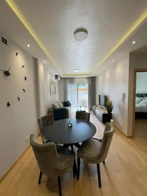 a living room with a table and chairs and a bedroom at Old barkery, the most exclusive complex in Budva in Budva