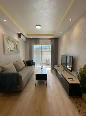 a living room with a couch and a tv at Old barkery, the most exclusive complex in Budva in Budva