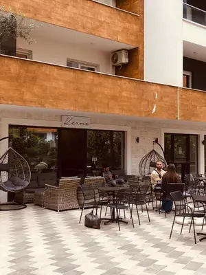 a group of people sitting at tables on a patio at Old barkery, the most exclusive complex in Budva in Budva