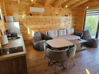 a living room with a couch and a table at Estuary Cottage Ada Bojana in Ulcinj