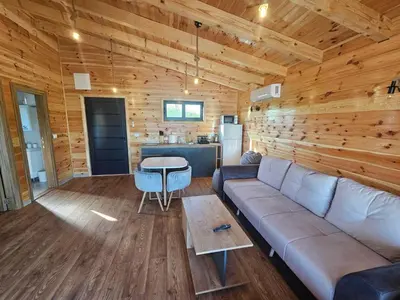 a living room with a couch and a table at Estuary Cottage Ada Bojana in Ulcinj