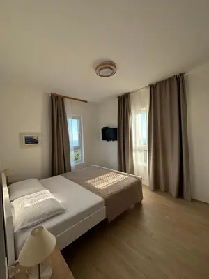 a bedroom with a large bed and a window at Villa Žukovica in Petrovac na Moru