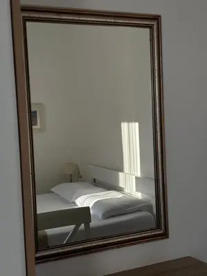 a mirror reflection of a bed in a bedroom at Villa Žukovica in Petrovac na Moru