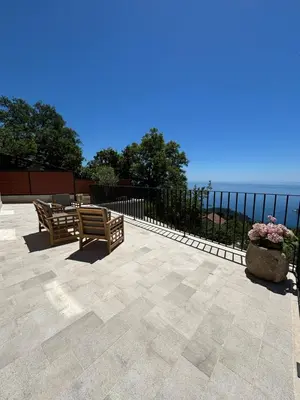 a patio with two benches and a fence at Villa Žukovica in Petrovac na Moru