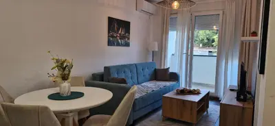 a living room with a blue couch and a table at Zira2 in Kotor